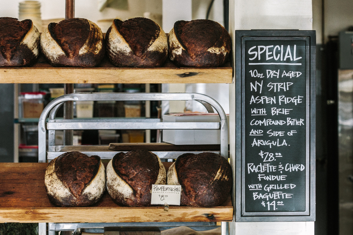 Loaves of bread with chalkboard sign